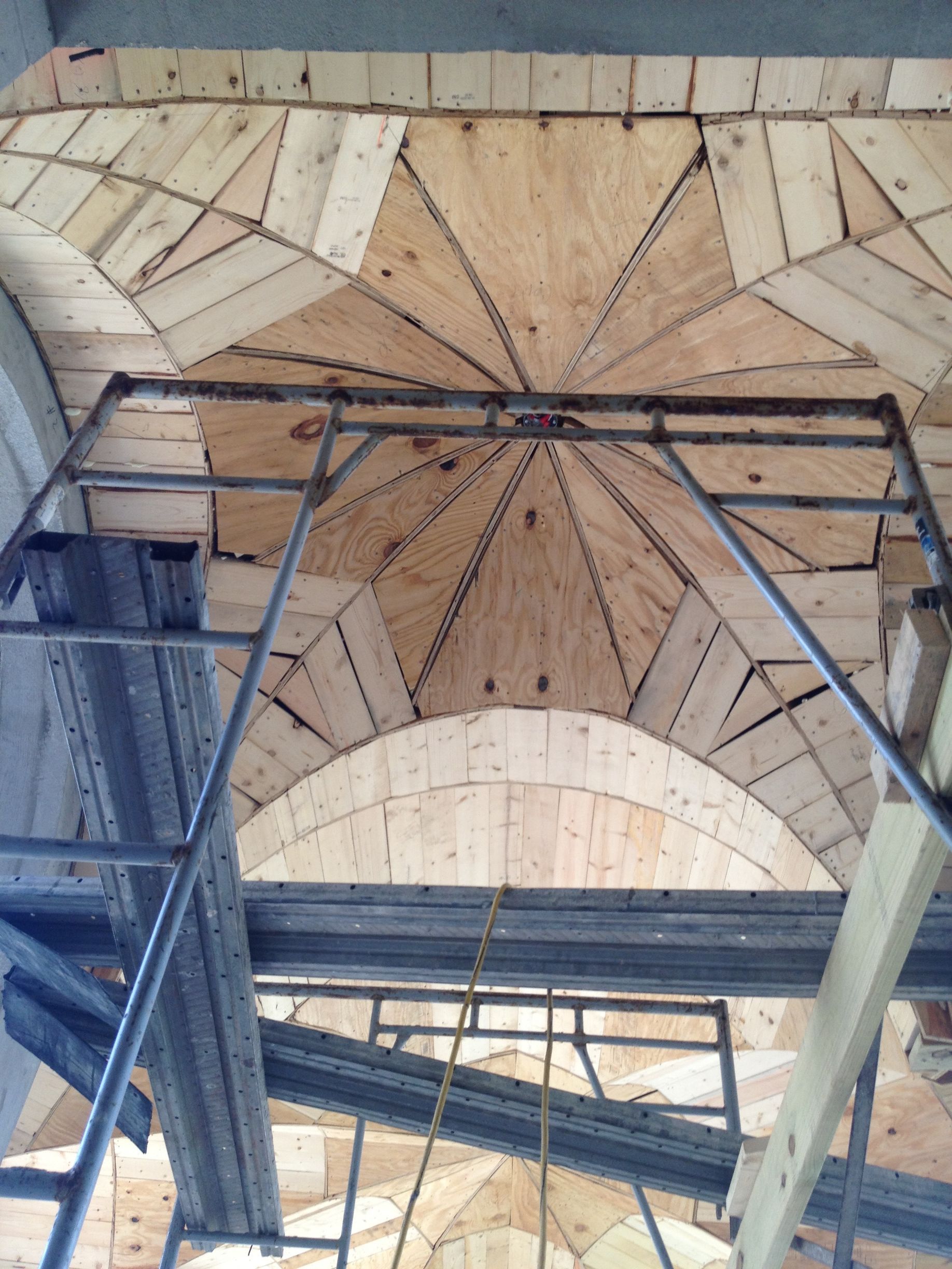 Wooden dome under construction with scaffolding.