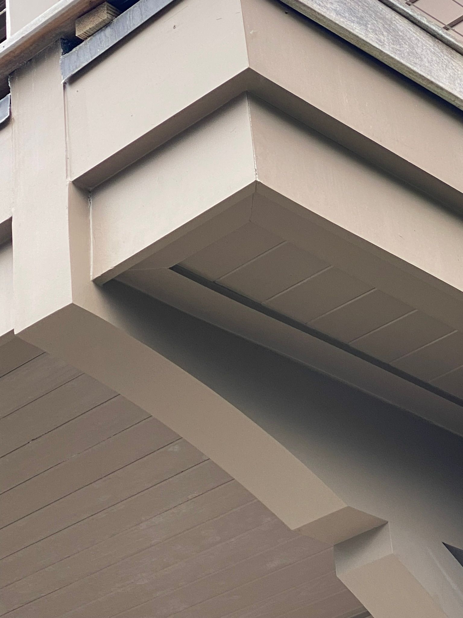 Beige building exterior with angular architectural details.