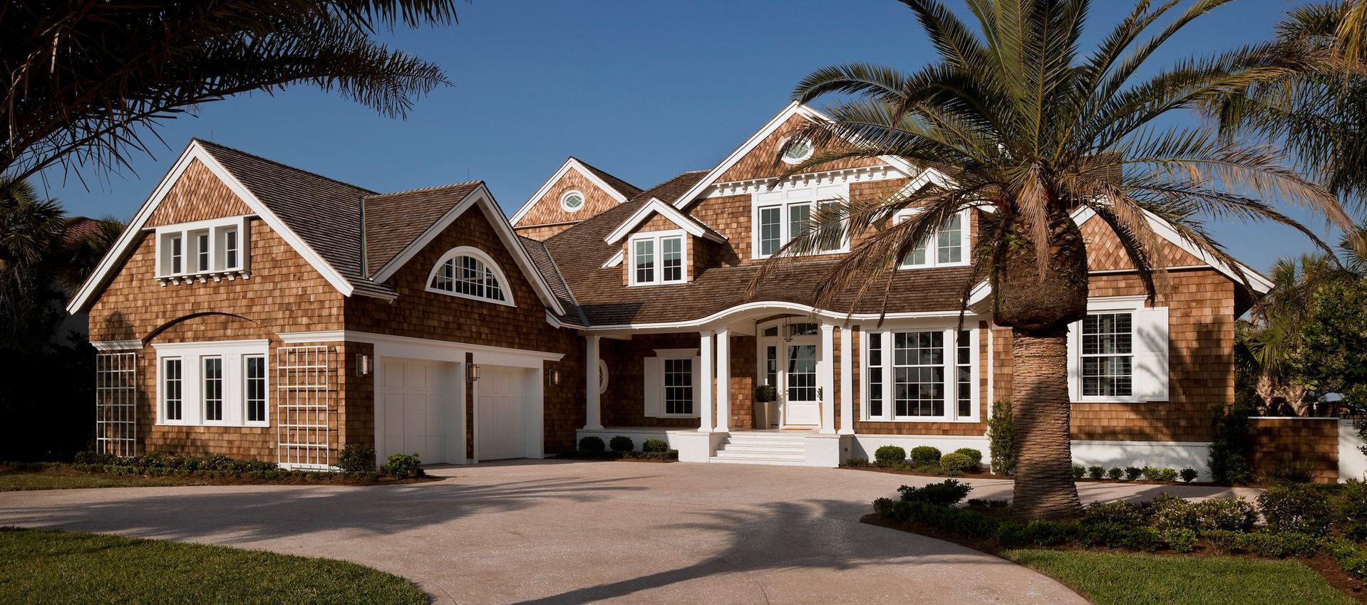A large house with a palm tree in front of it