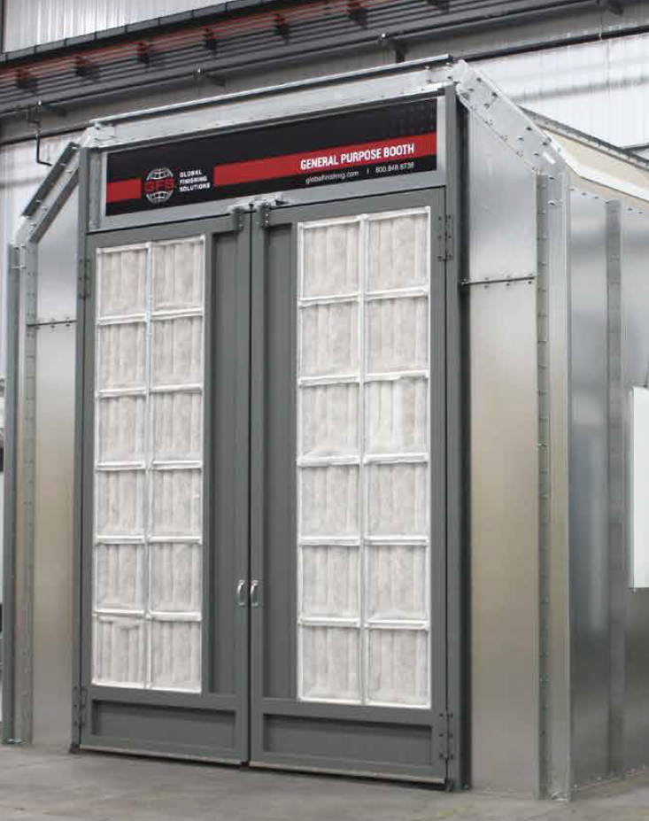 A gray paint booth with two doors covered in filter panels, indoors.