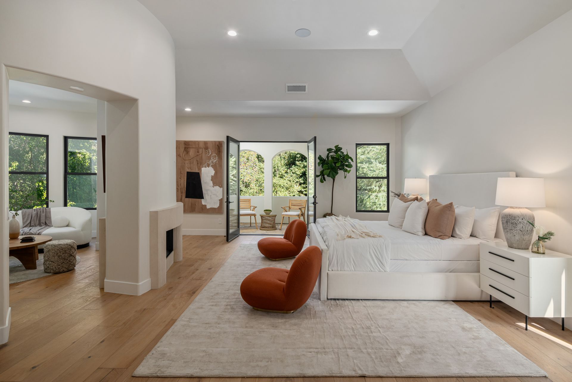 A large bedroom with a large bed and two chairs