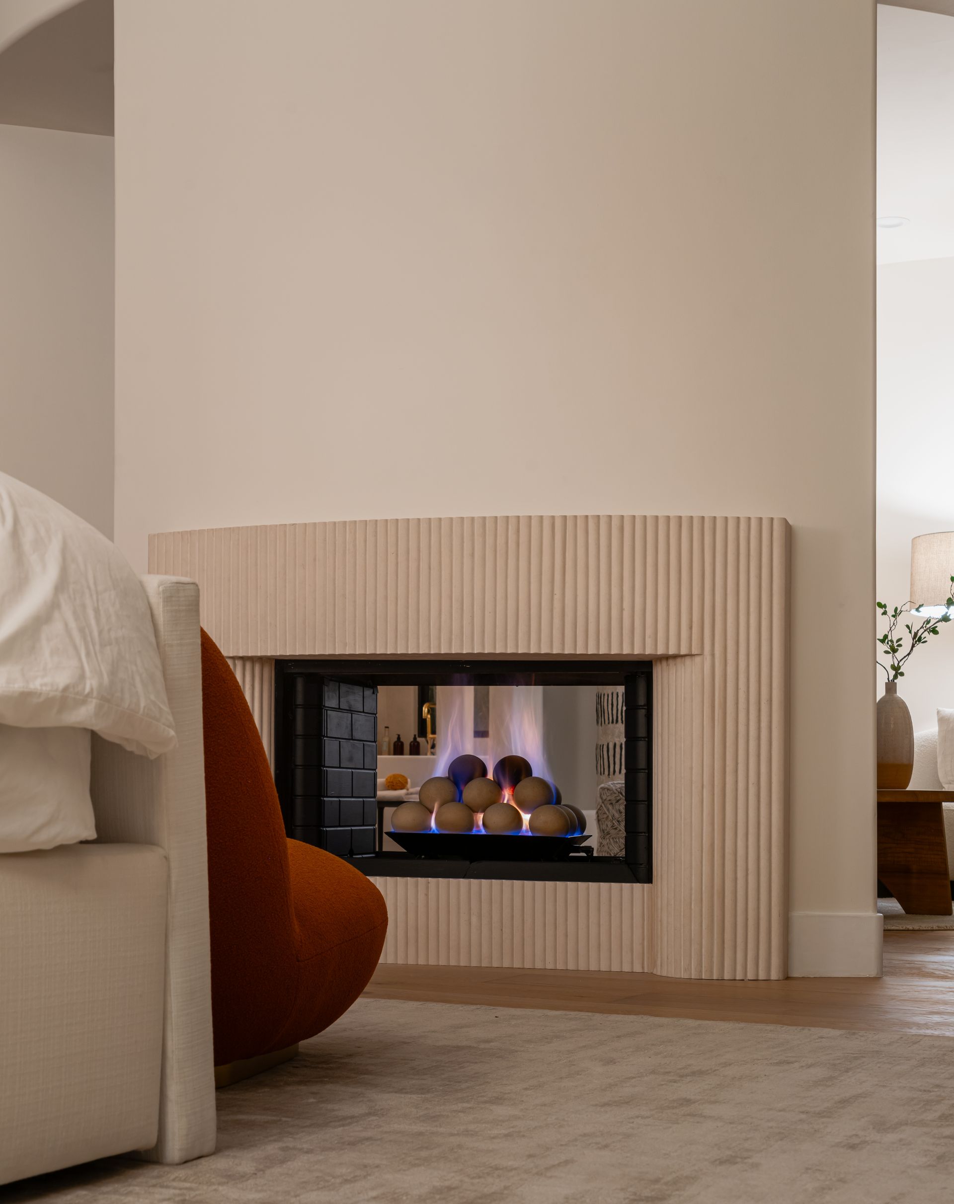 A living room with a fireplace and a chair
