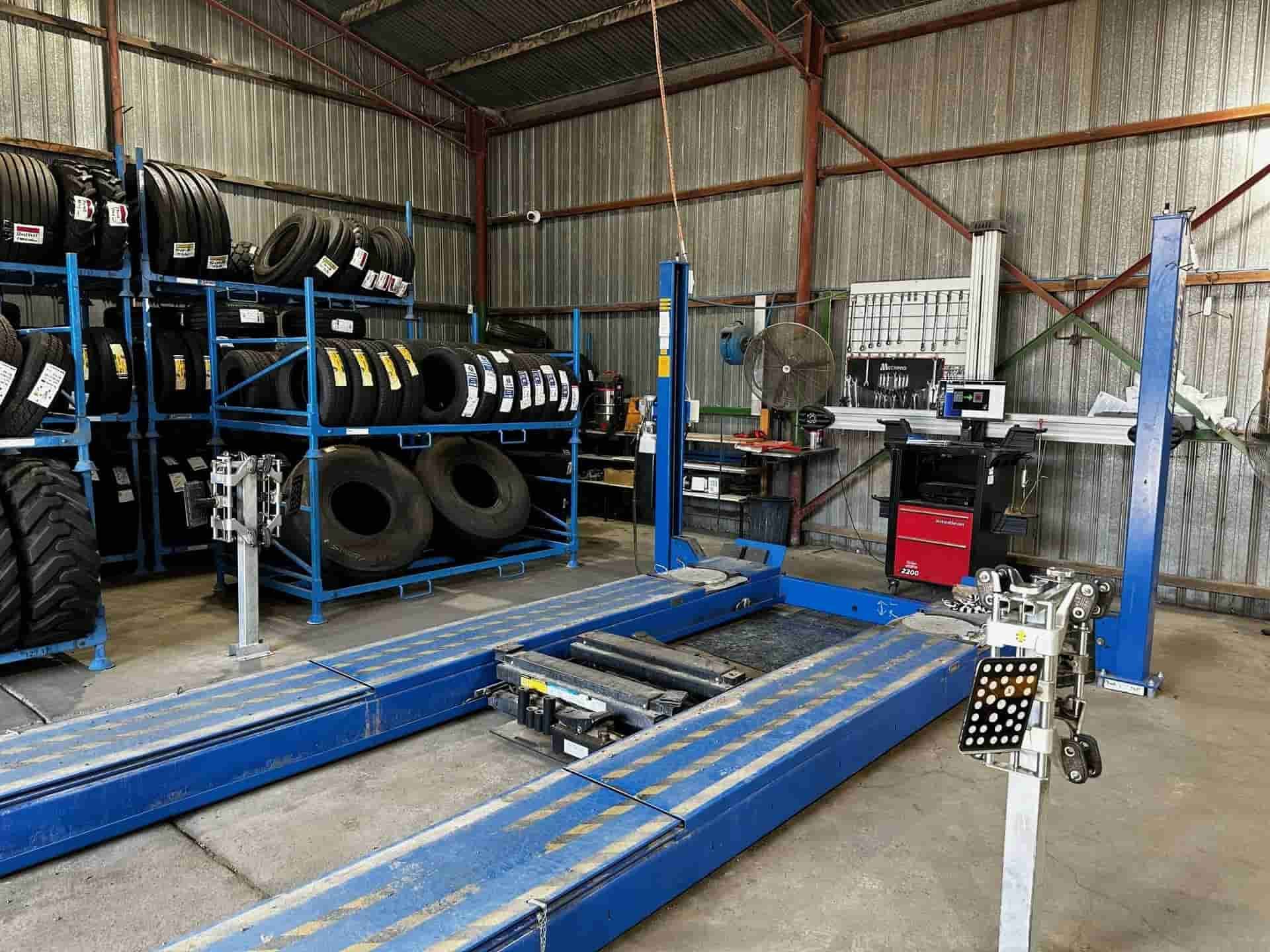 A Warehouse Filled With Lots Of Tires And A Lift — Smitty's Tyres & More In Taminda, NSW