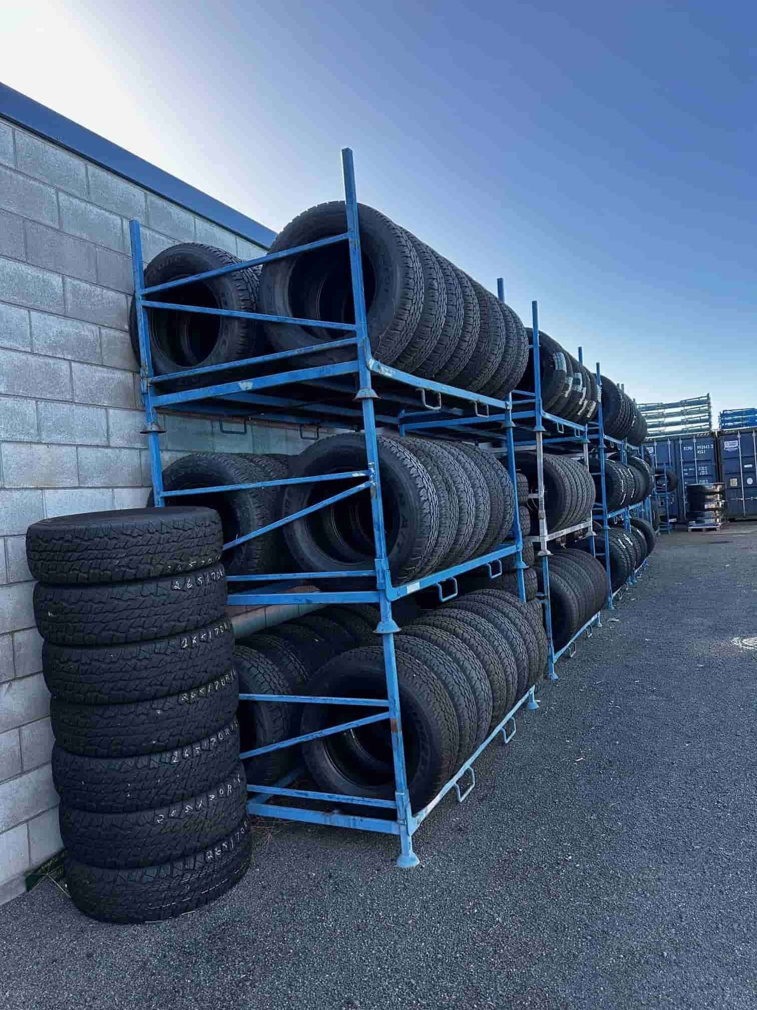 A Bunch Of Tires Are Stacked On Top Of Each Other On A Rack — Smitty's Tyres & More In Taminda, NSW