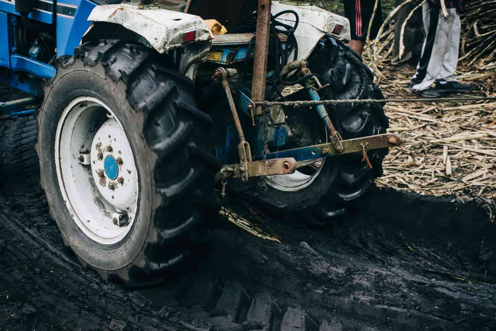 A Blue And White Tractor Is Parked On A Dirt Road — Smitty's Tyres & More In Taminda, NSW