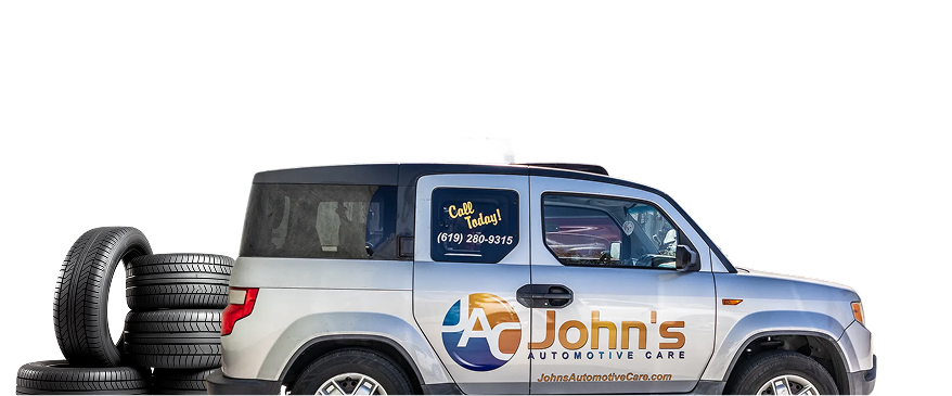 A silver SUV with stacked tires, advertising 