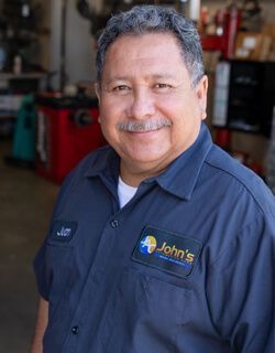 Smiling man in a blue uniform with the logo 