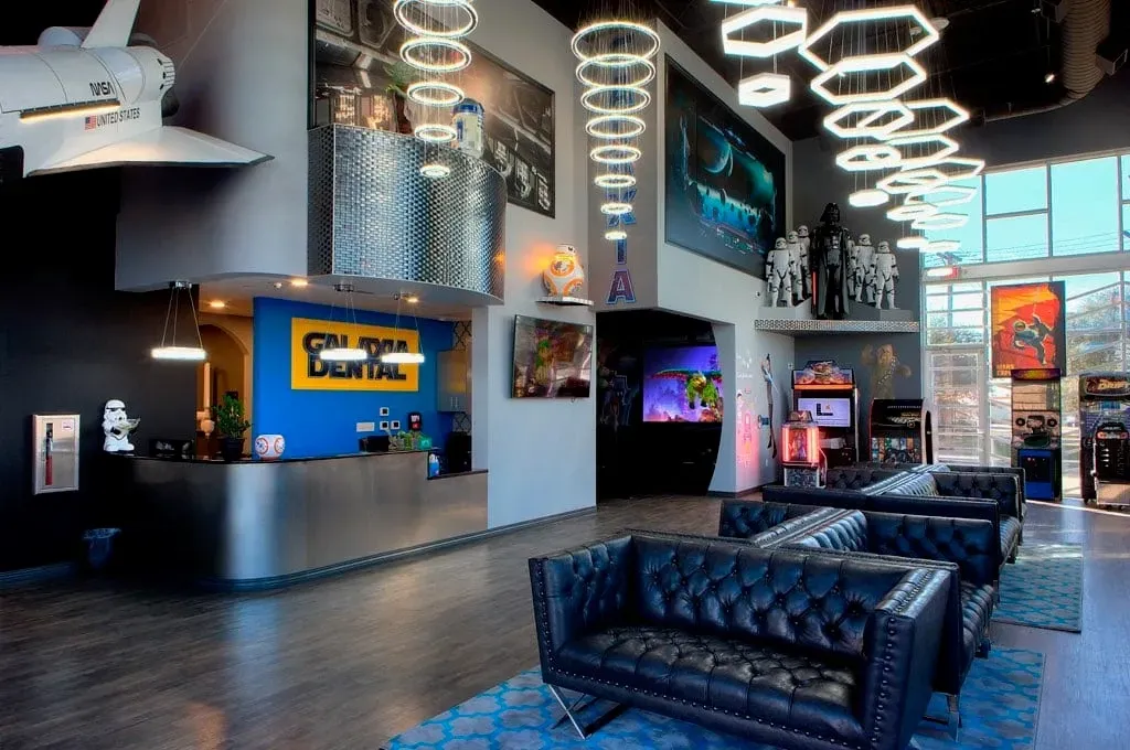 Modern office lobby with black tufted sofas, reception desk, and sci-fi decor like a space shuttle.