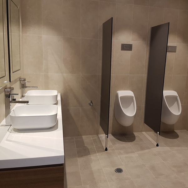 a bathroom with two sinks and two urinals .