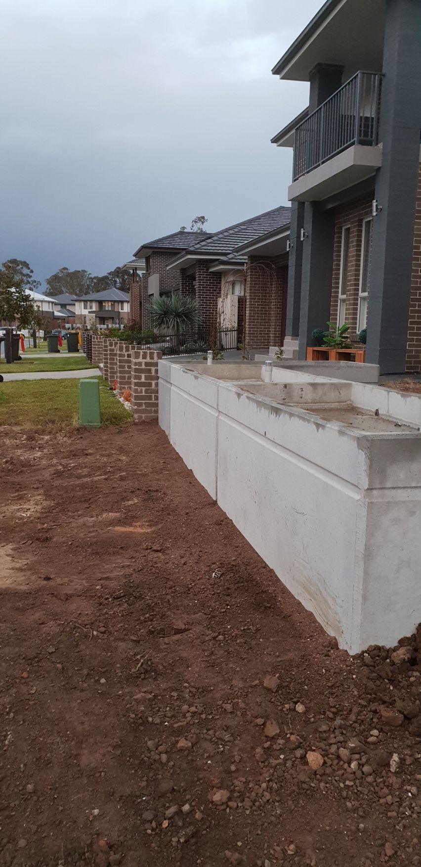 a concrete wall is being built in front of a house .