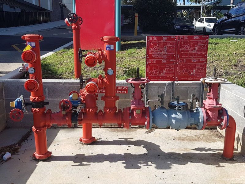 a bunch of red pipes are sitting on the ground