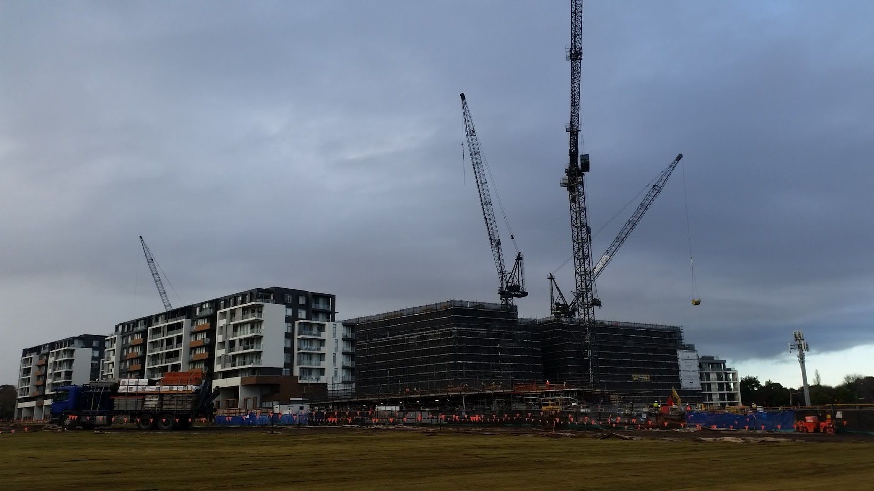 a large building is being built with cranes in the background .