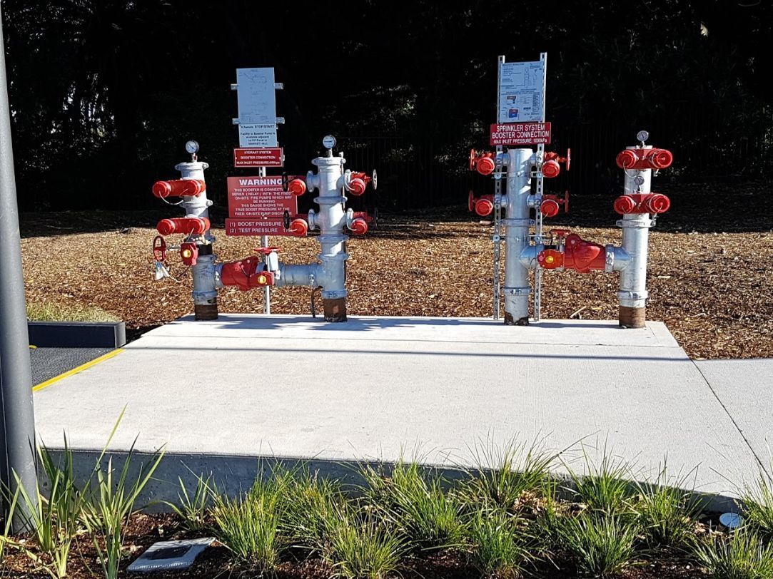 a fire hydrant is sitting on the side of the road .