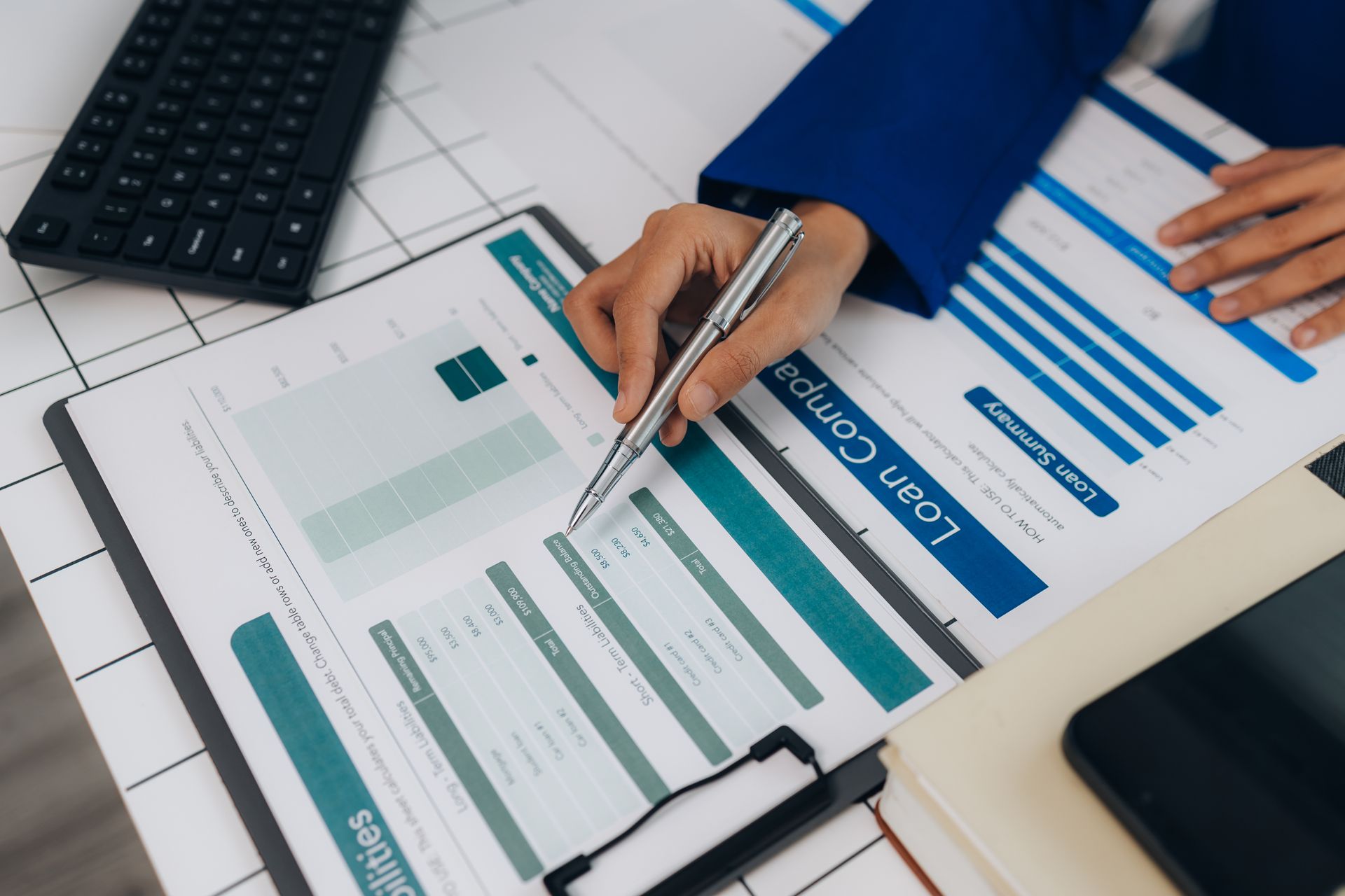 A person is writing on a clipboard with a pen.
