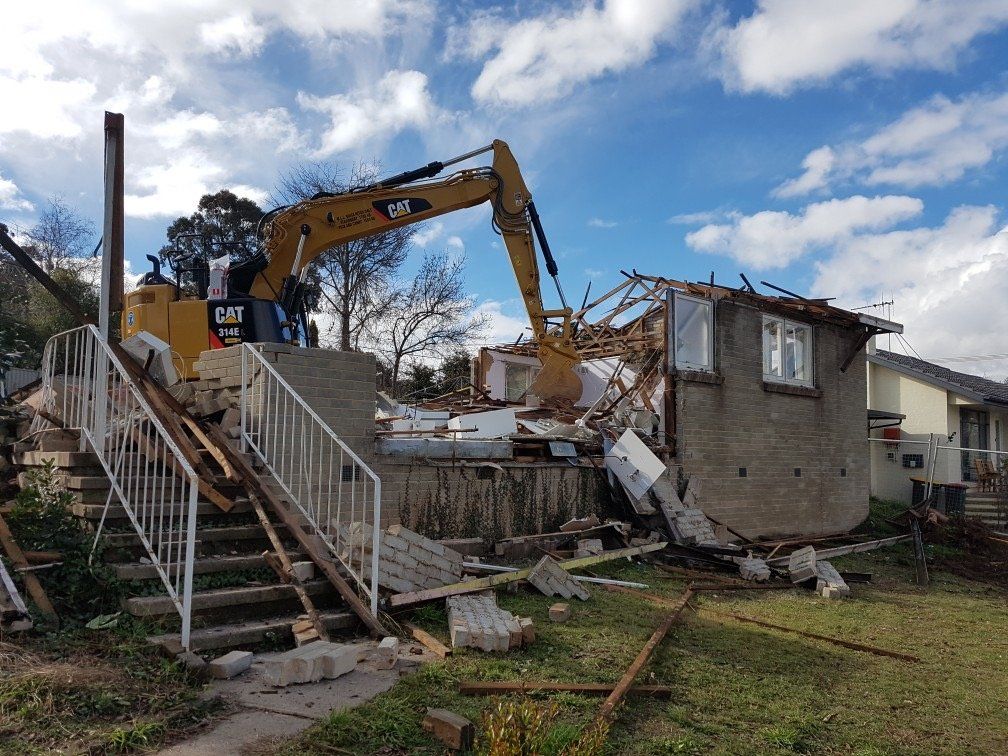 An excavator demolishing a house on the Sunshine Coast — Allcoast Group Demolition Contractors