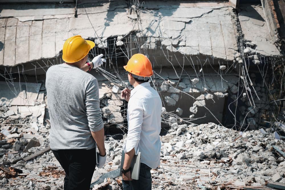 Demolition Contractors In Front Of A Demolished Structure