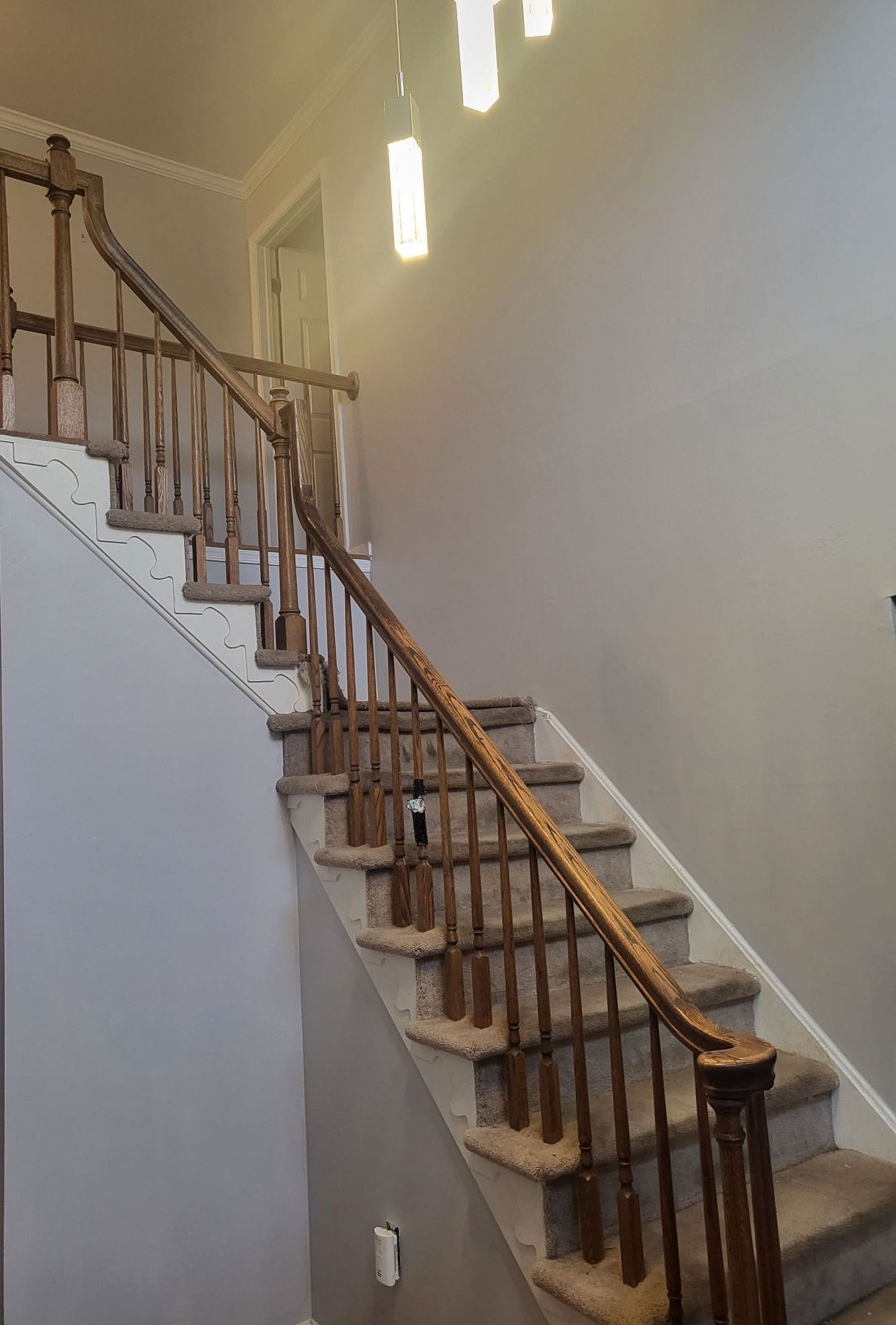 A staircase with a wooden railing in a house.