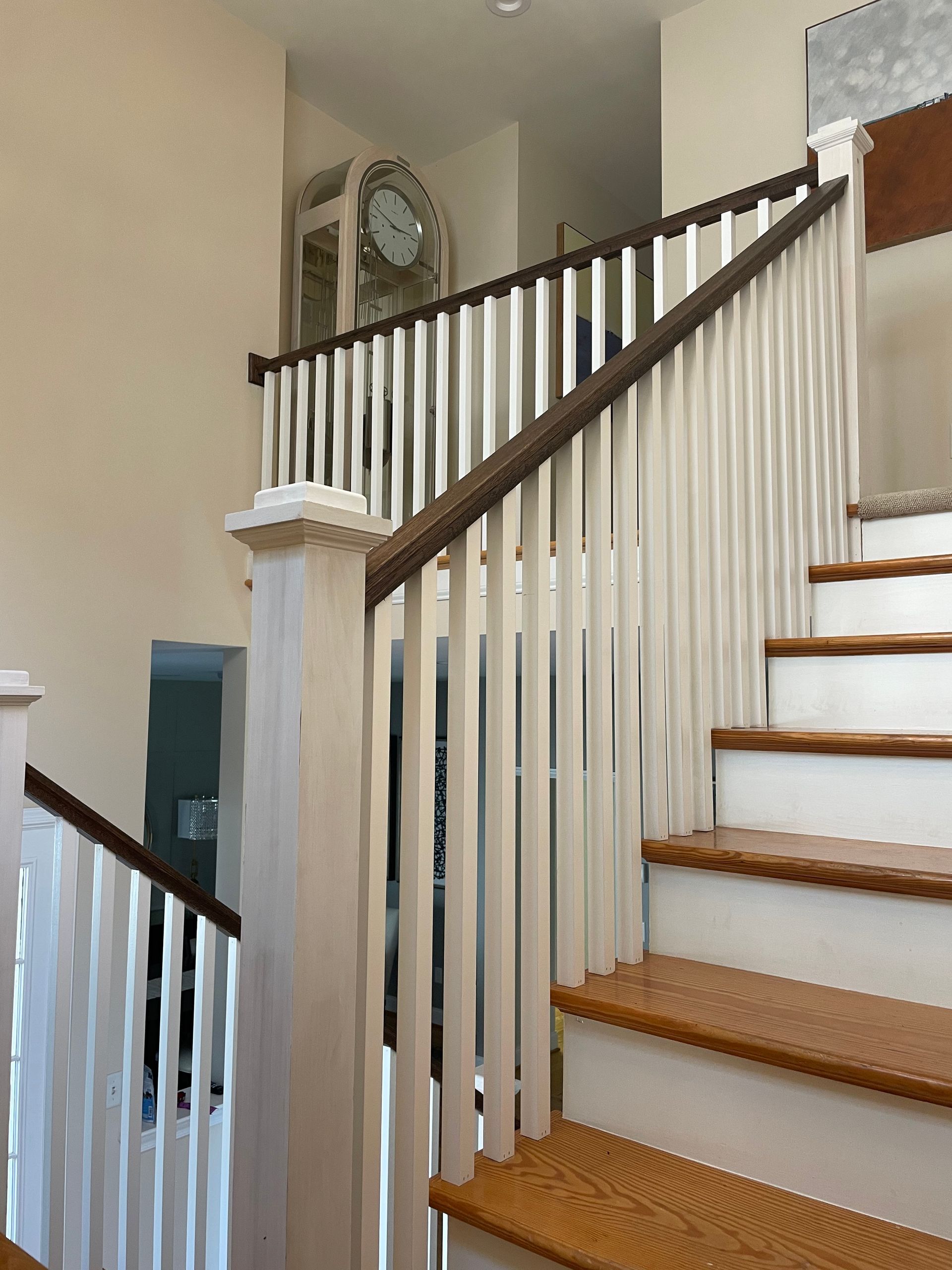 A staircase with a white railing and wooden steps