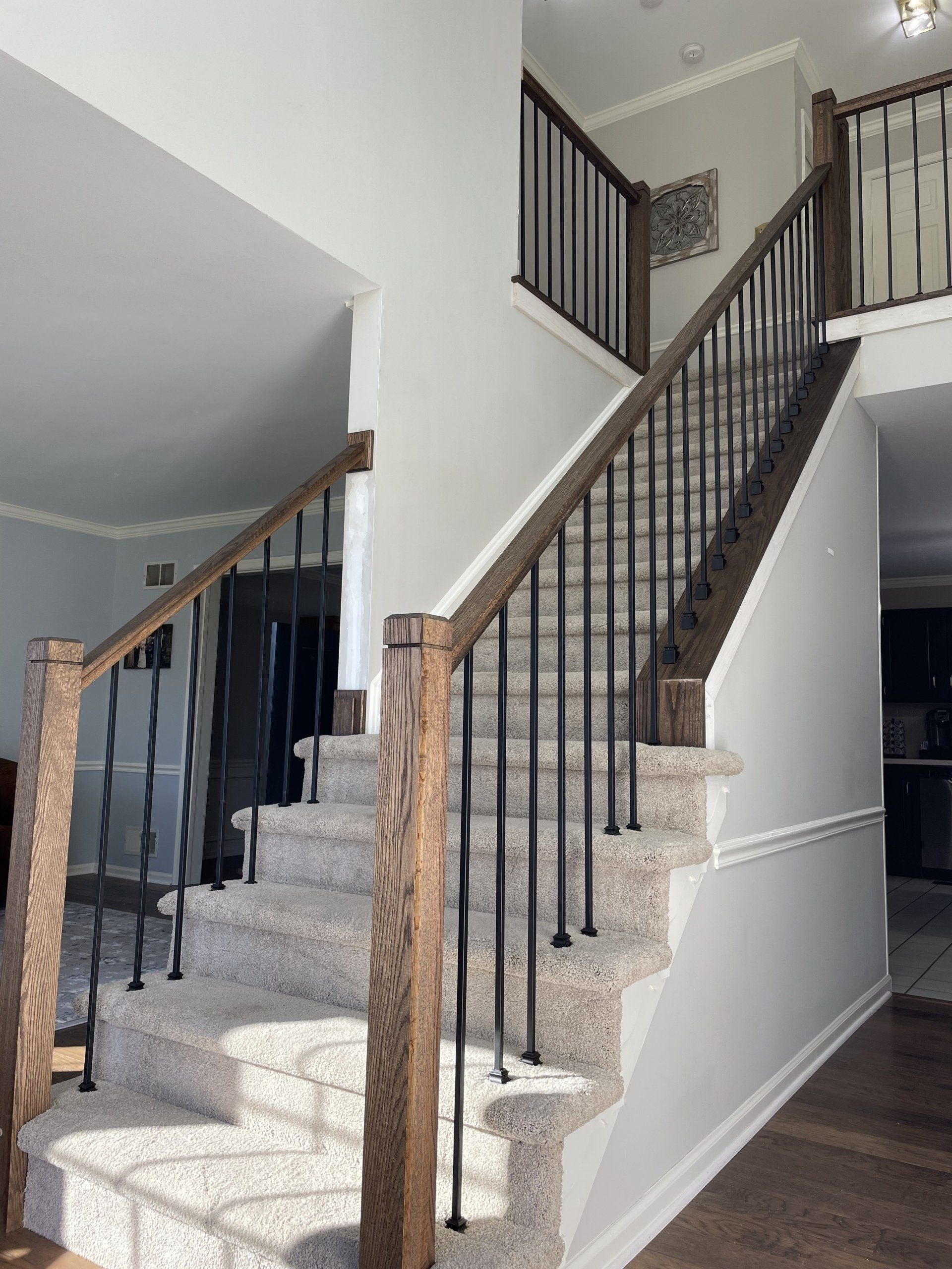 A staircase in a house with a wooden railing