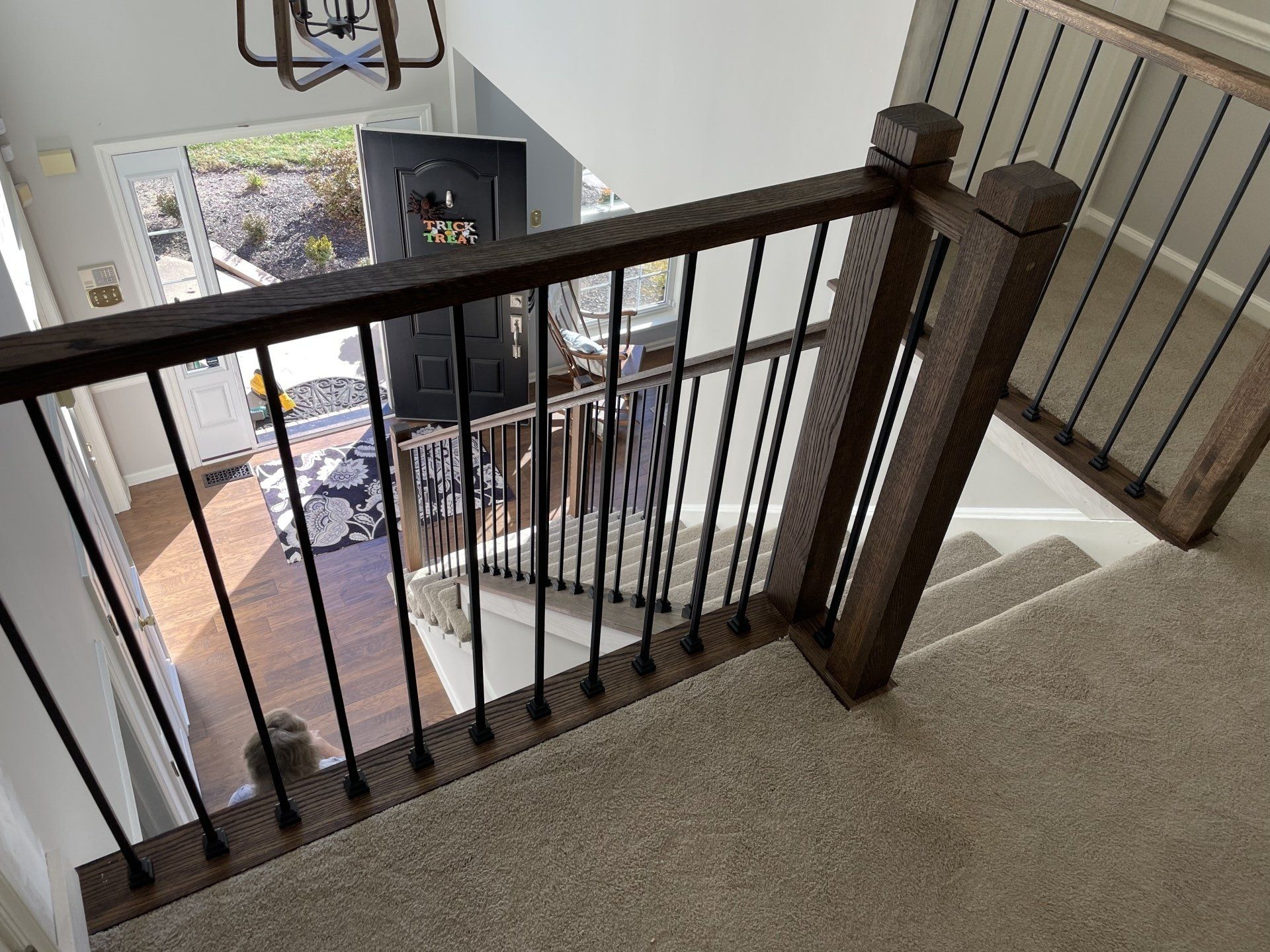 A view of a staircase from the second floor of a house.