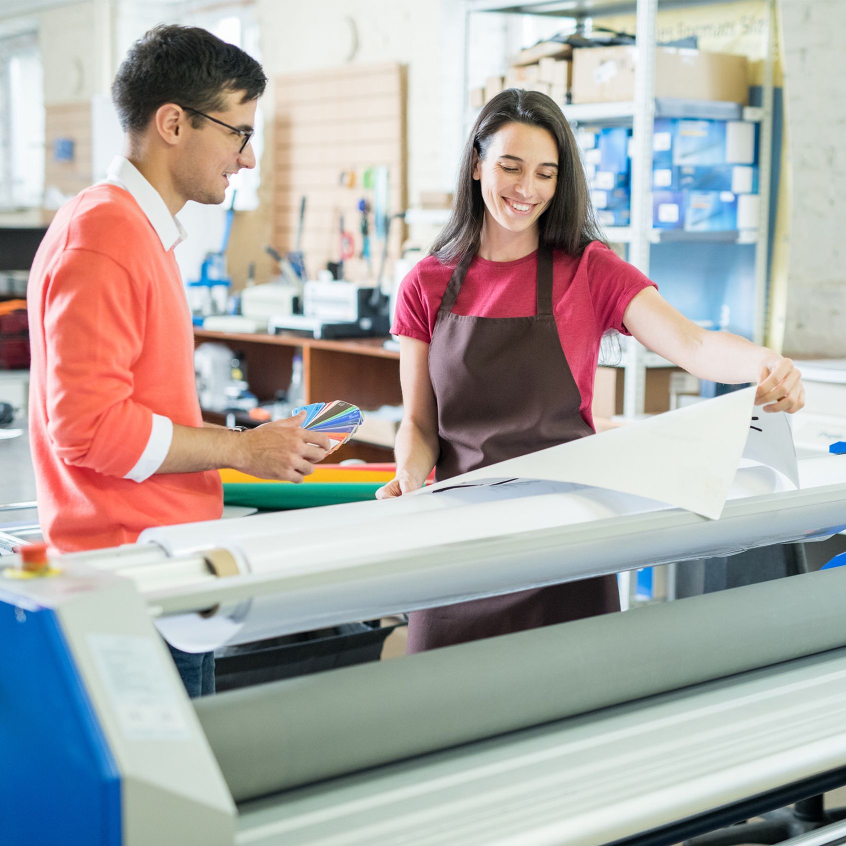Woman showing custom-printed banner to customer