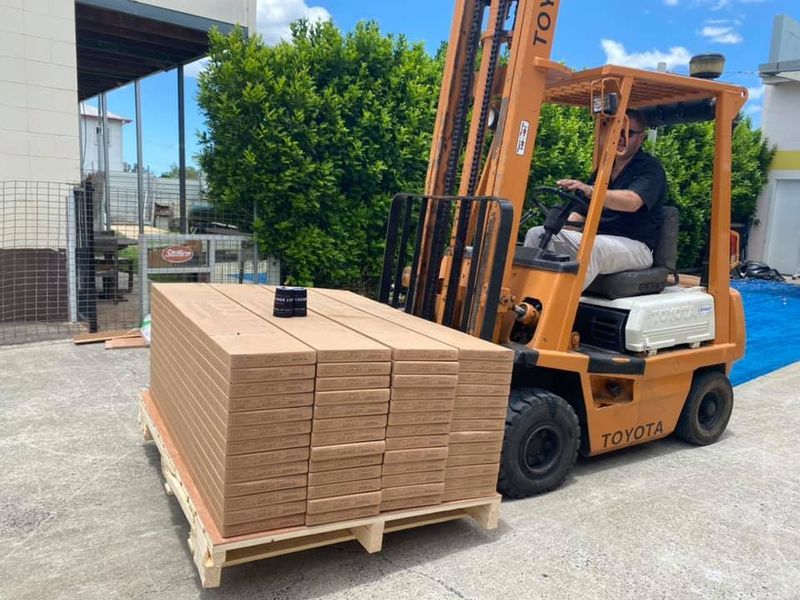 Forklift Operator In Orange Toyota Forklift — Mareeba Floor Covering Centre in Mareeba, QLD