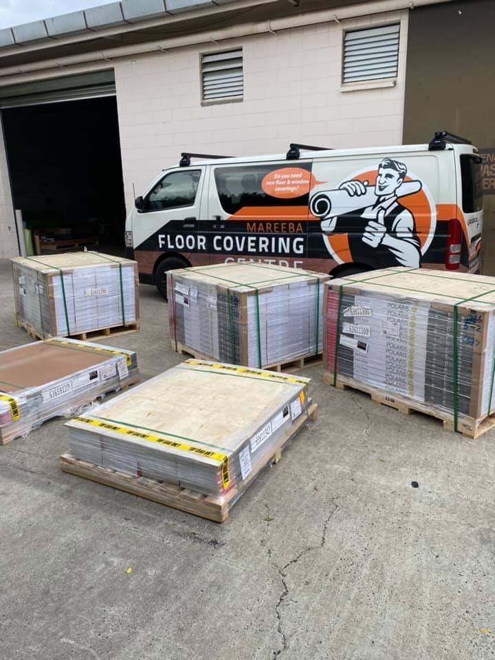 Pallets Of Flooring Materials Sit Outside A Warehouse — Mareeba Floor Covering Centre in Port Douglas, QLD