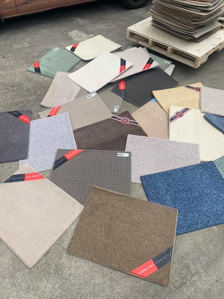Assortment Of Carpet Samples In Various Colors On A Concrete Surface — Mareeba Floor Covering Centre in Mareeba, QLD