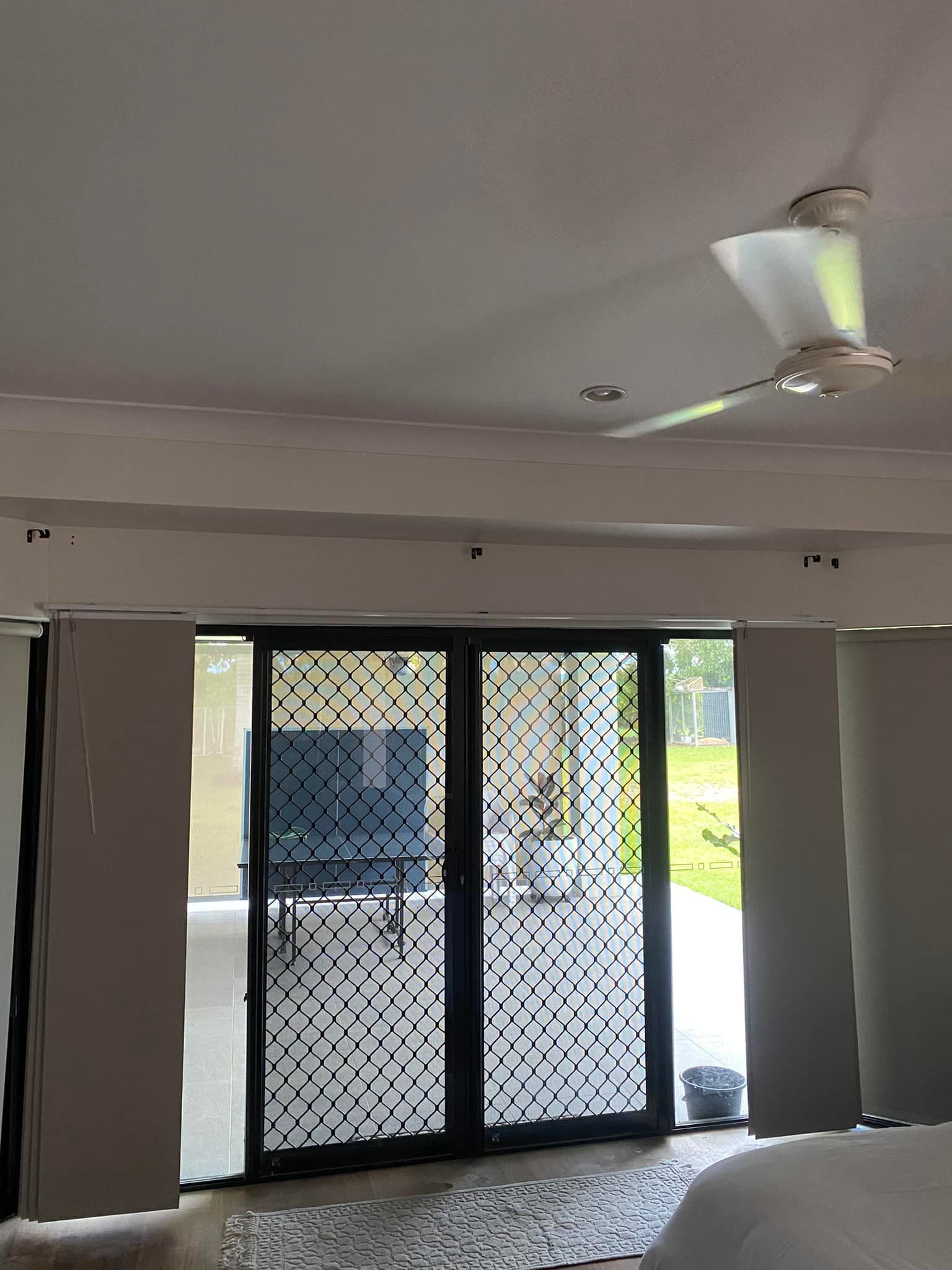 Sliding glass doors with a decorative pattern, open to a patio. A ceiling fan is visible — Mareeba Floor Covering Centre in Cassowary Coast, QLD