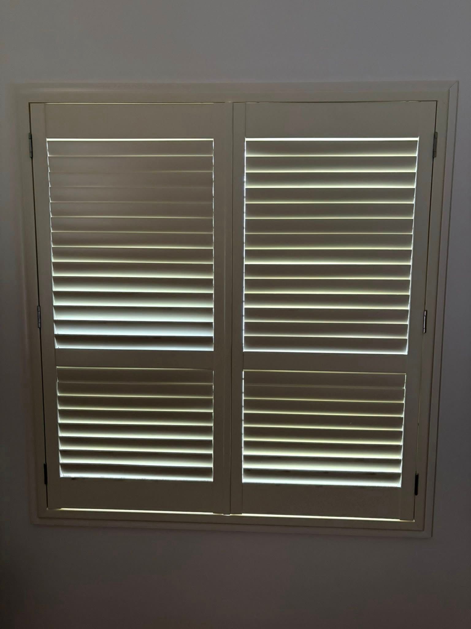 Window With Closed, Cream-colored Shutters — Mareeba Floor Covering Centre in Tablelands, QLD