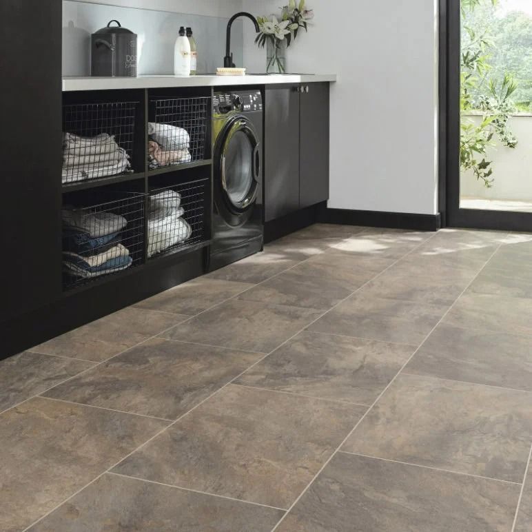 Laundry Room With Dark Cabinets, Washer, And Stacked Towels — Mareeba Floor Covering Centre in Cape York, QLD