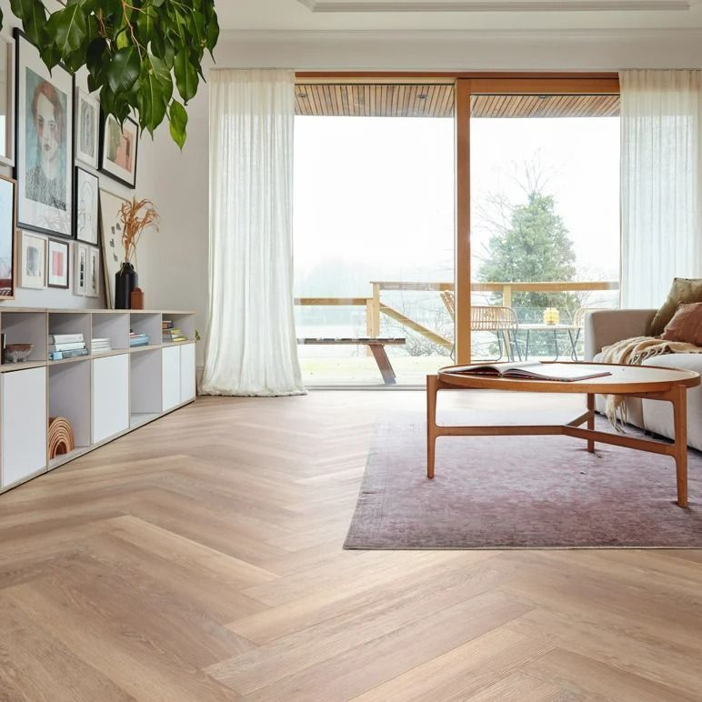 Living room with wooden floors, neutral color palette, large window, and light-colored furniture — Mareeba Floor Covering Centre in Port Douglas, QLD