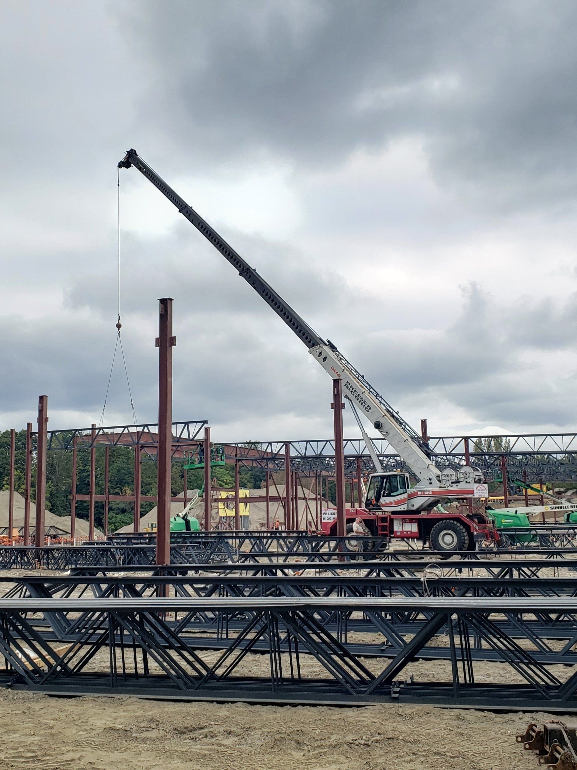 A large crane is working on a construction site