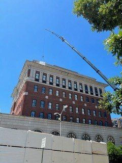 A large brick building with a crane on top of it.