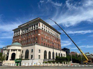 A large building with a crane in front of it.