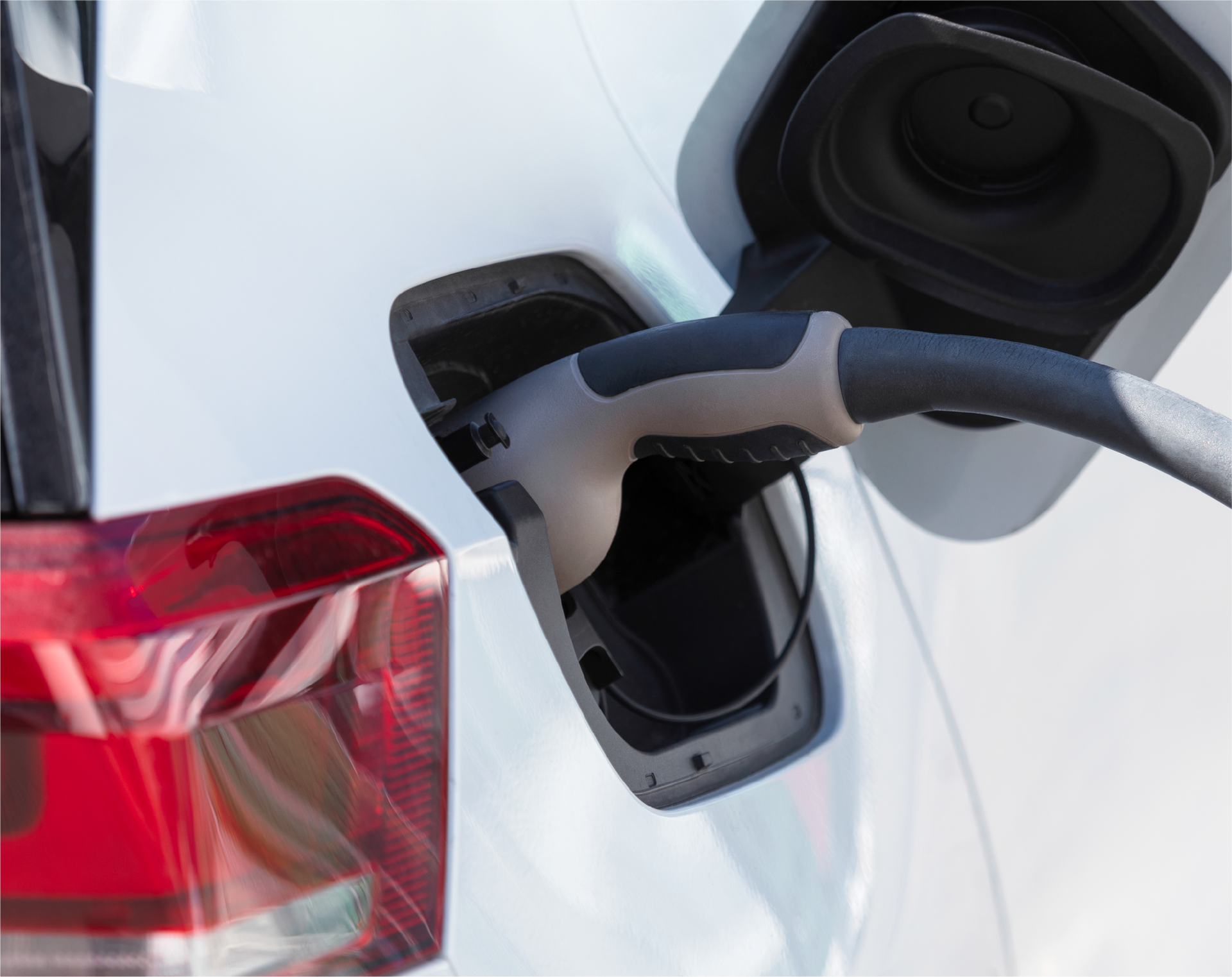 A person is charging an electric car with a charger.