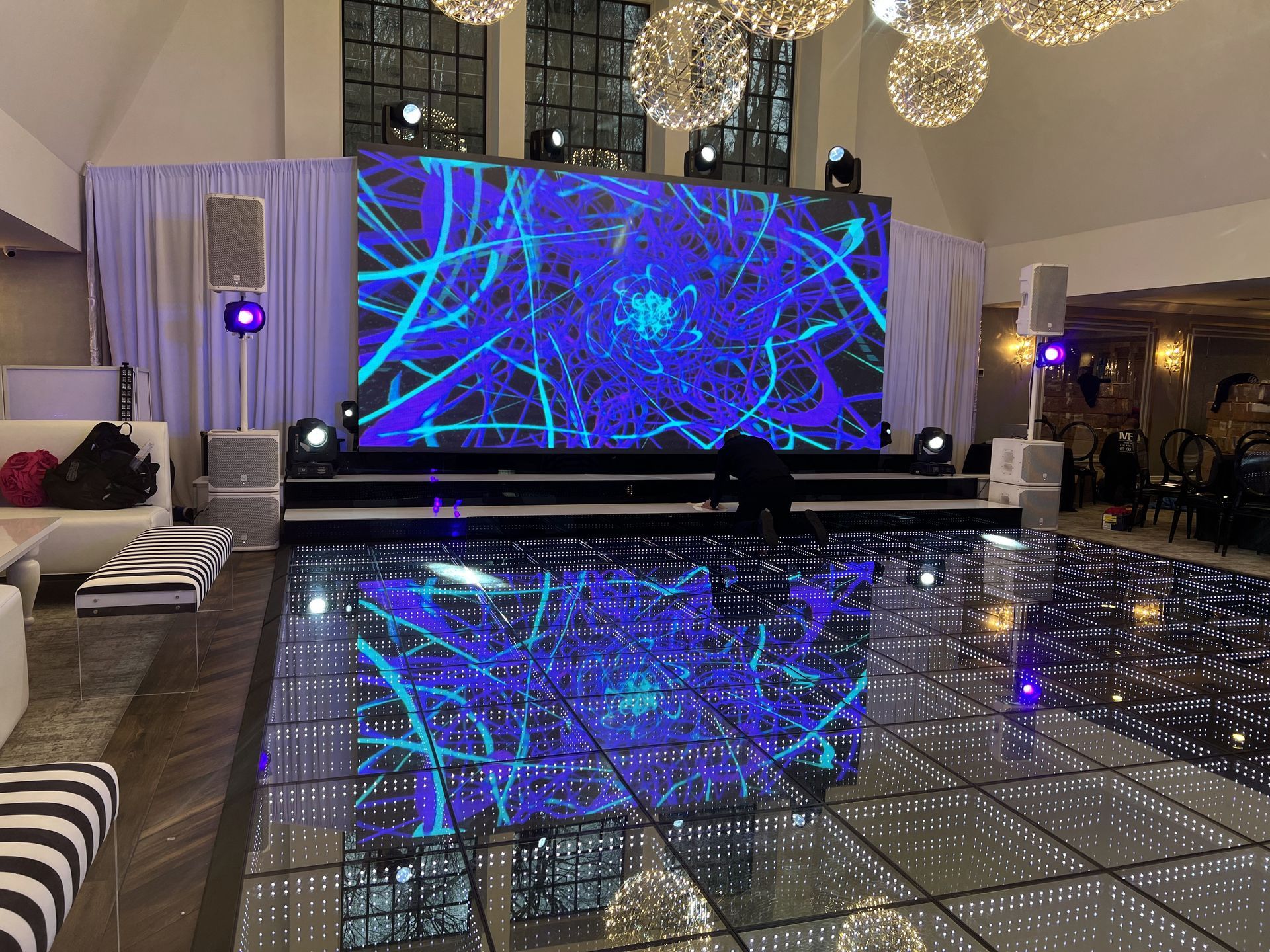 LED Video Wall and A large screen is behind a dance floor in a large room.