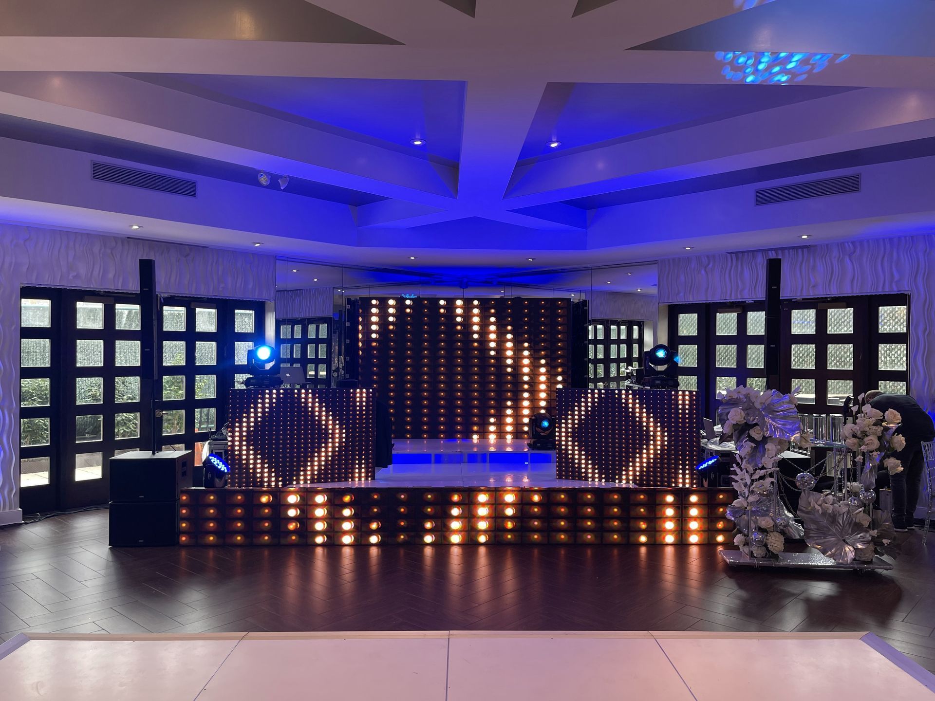 LED Video Wall and A large room with a dance floor and a stage with lights on it.
