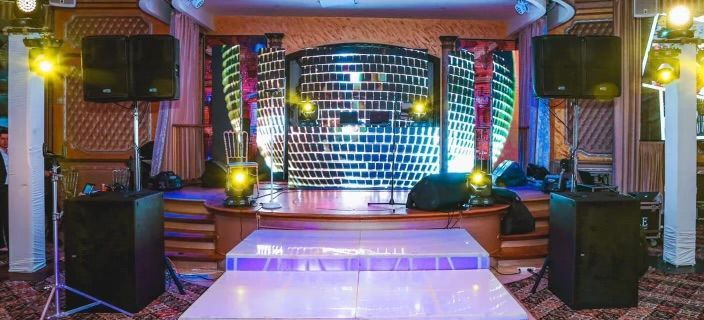 LED Video Wall and There is a dance floor in the middle of the room.