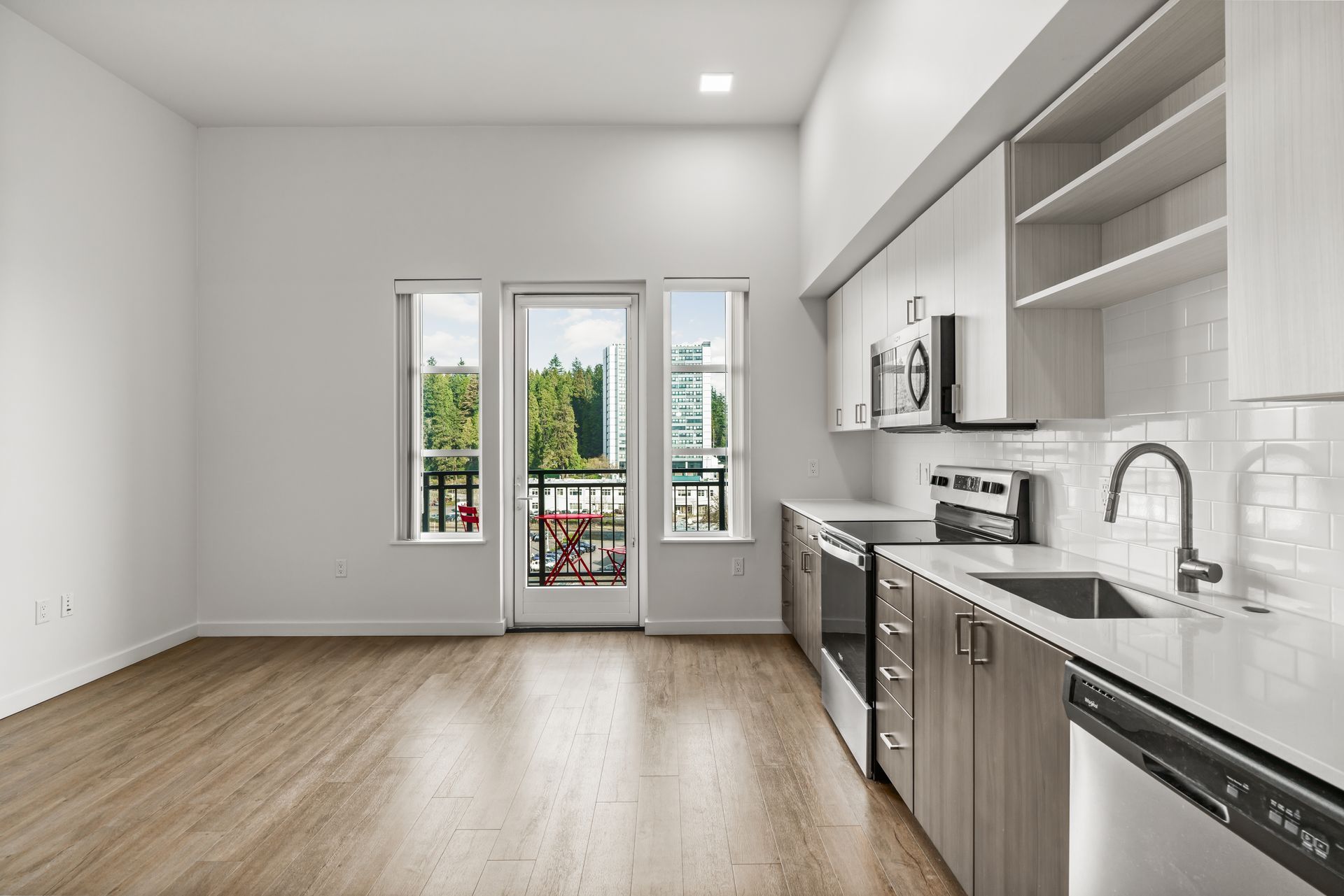 A light-filled studio apartment on the upper floors of Gordon Lofts in Eugene features large windows, a private balcony and modern finishes, including quartz countertops and stainless steel appliances. The elevated position brings in abundant natural light and open neighborhood views.