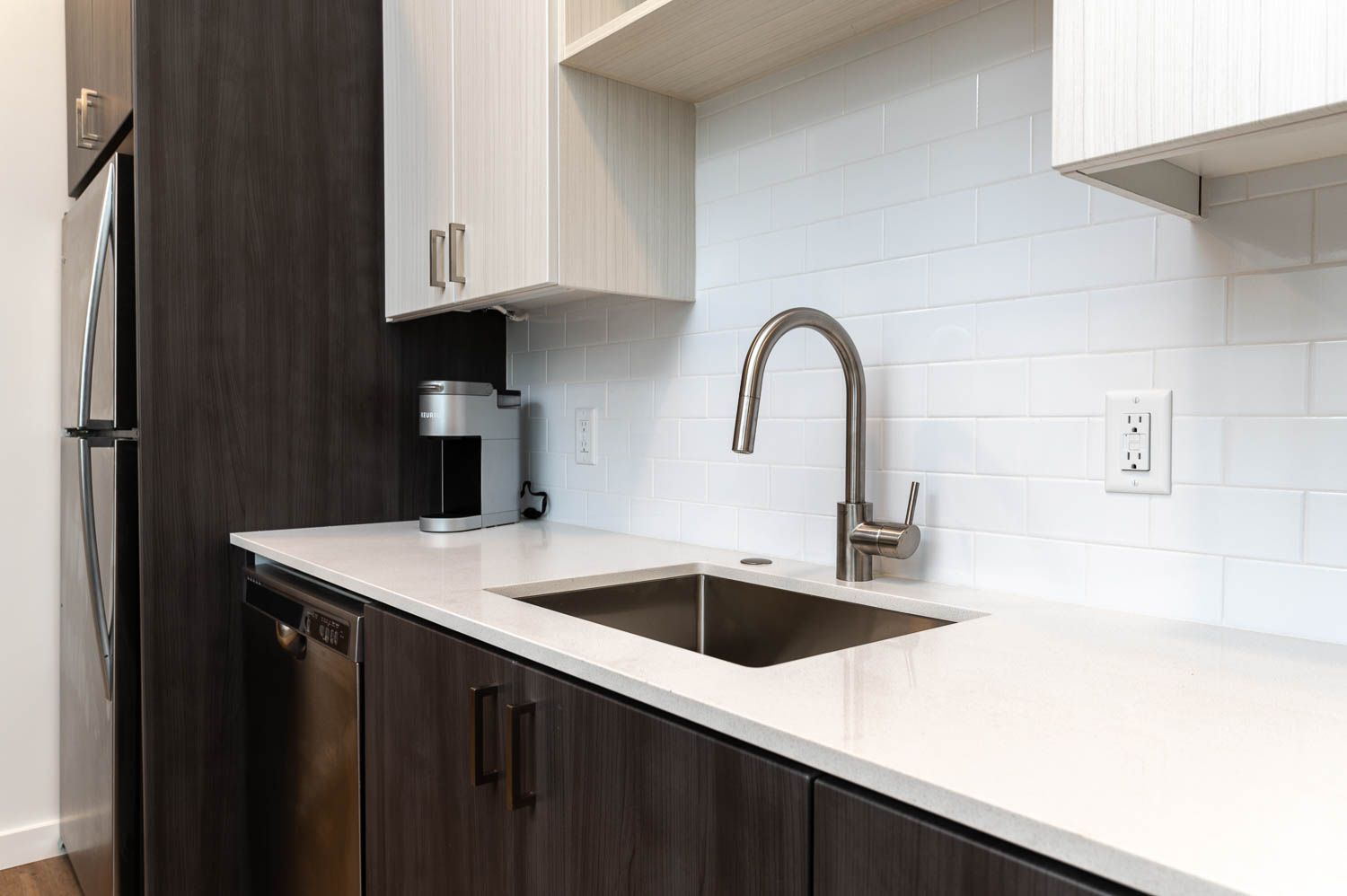 photo of kitchen sink with white countertops