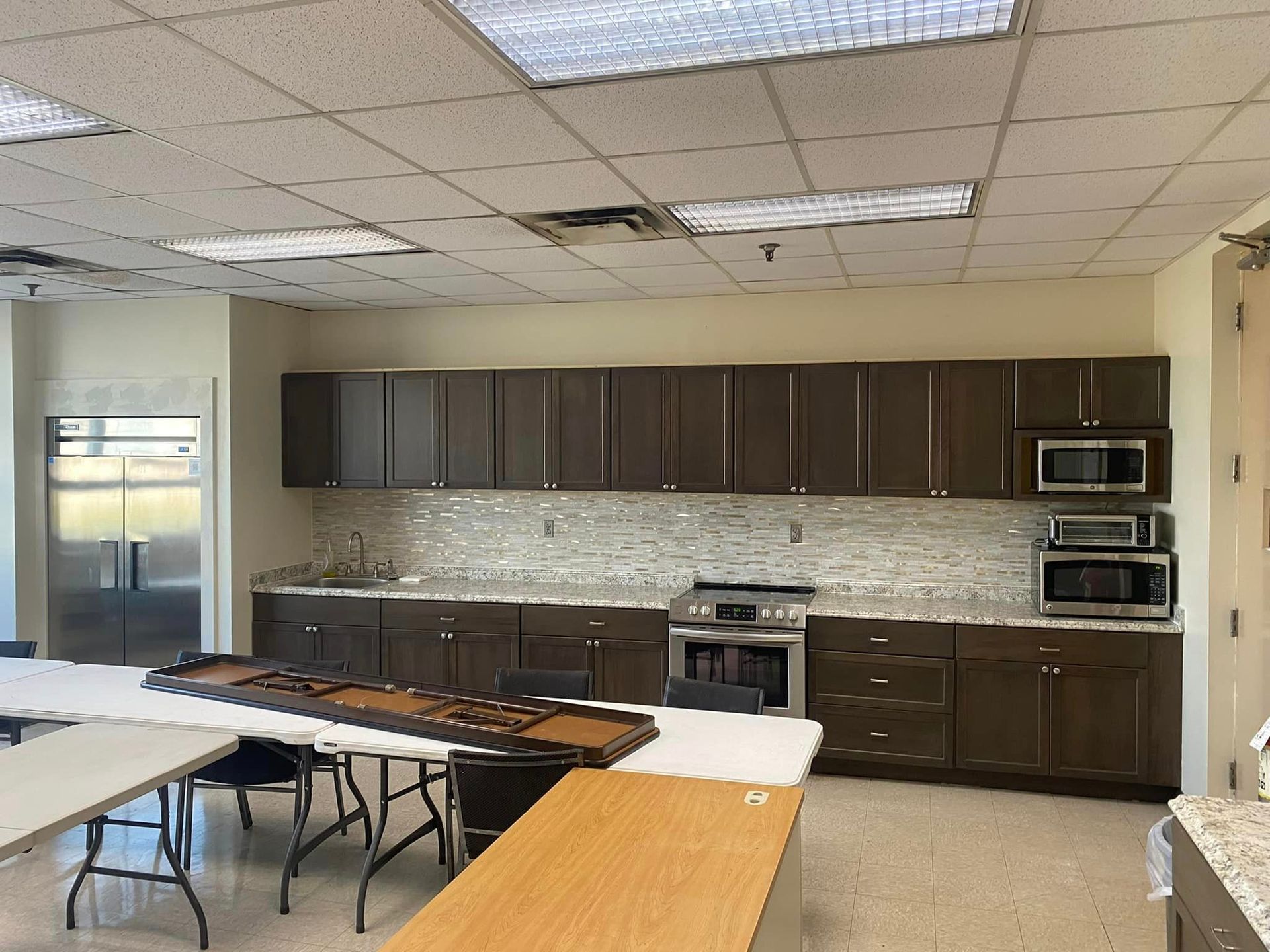 A kitchen with brown cabinets and white counter tops