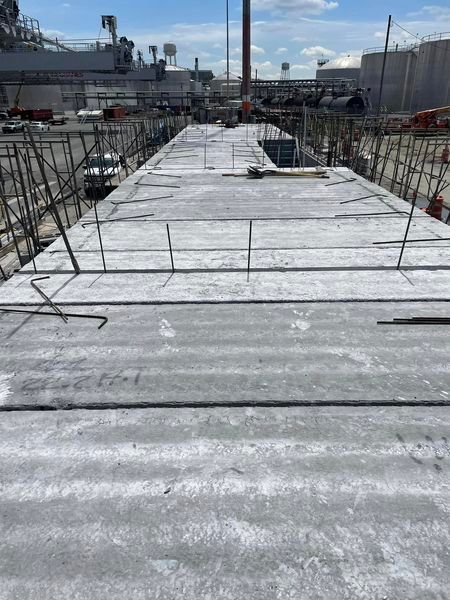 A large concrete structure is being built in a construction site.