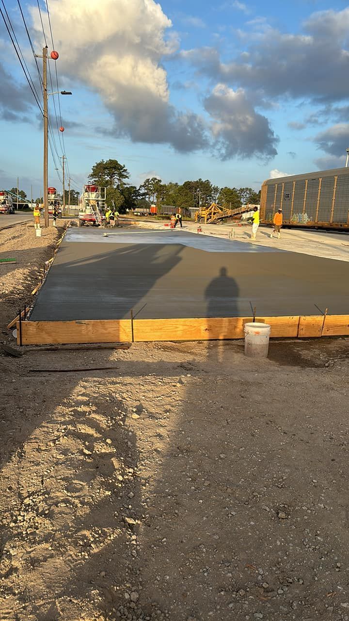A concrete slab is being built on the side of a road.