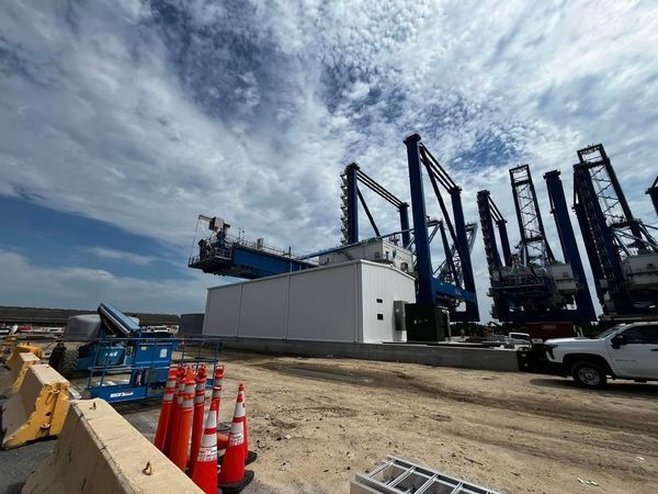 A construction site with a lot of cranes and cones