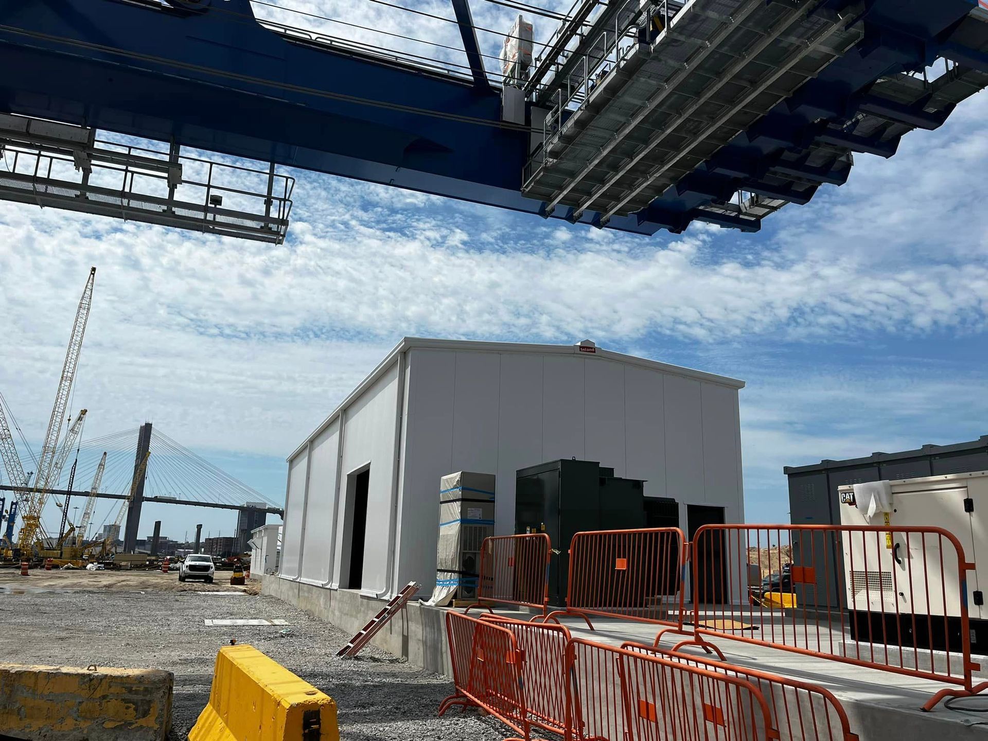 A large crane is lifting a building in a construction site.