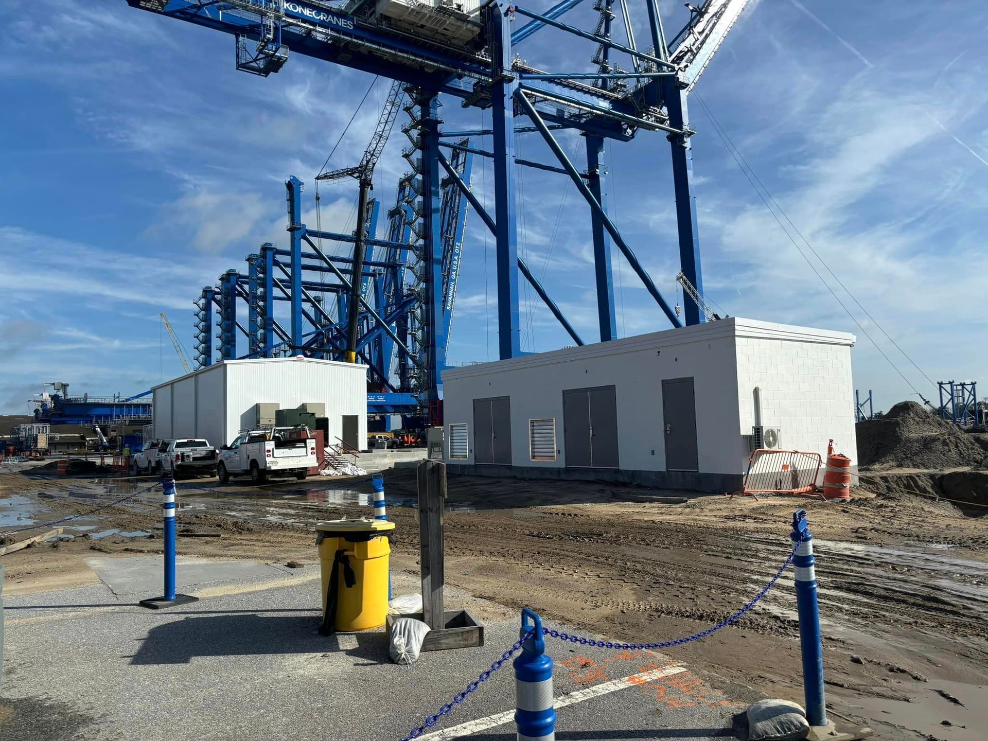 A construction site with a lot of cranes and buildings