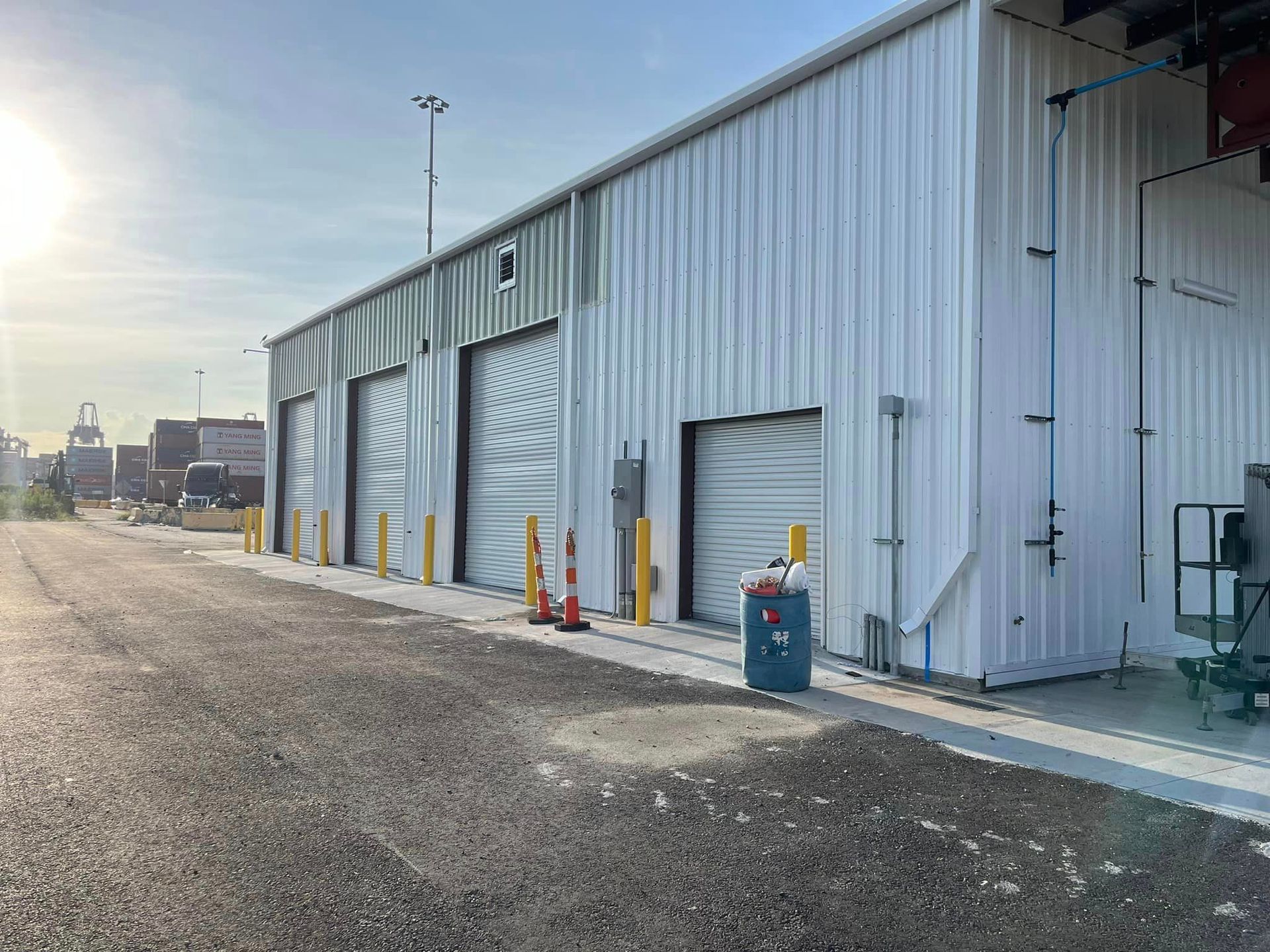 A large white building with a lot of garage doors.