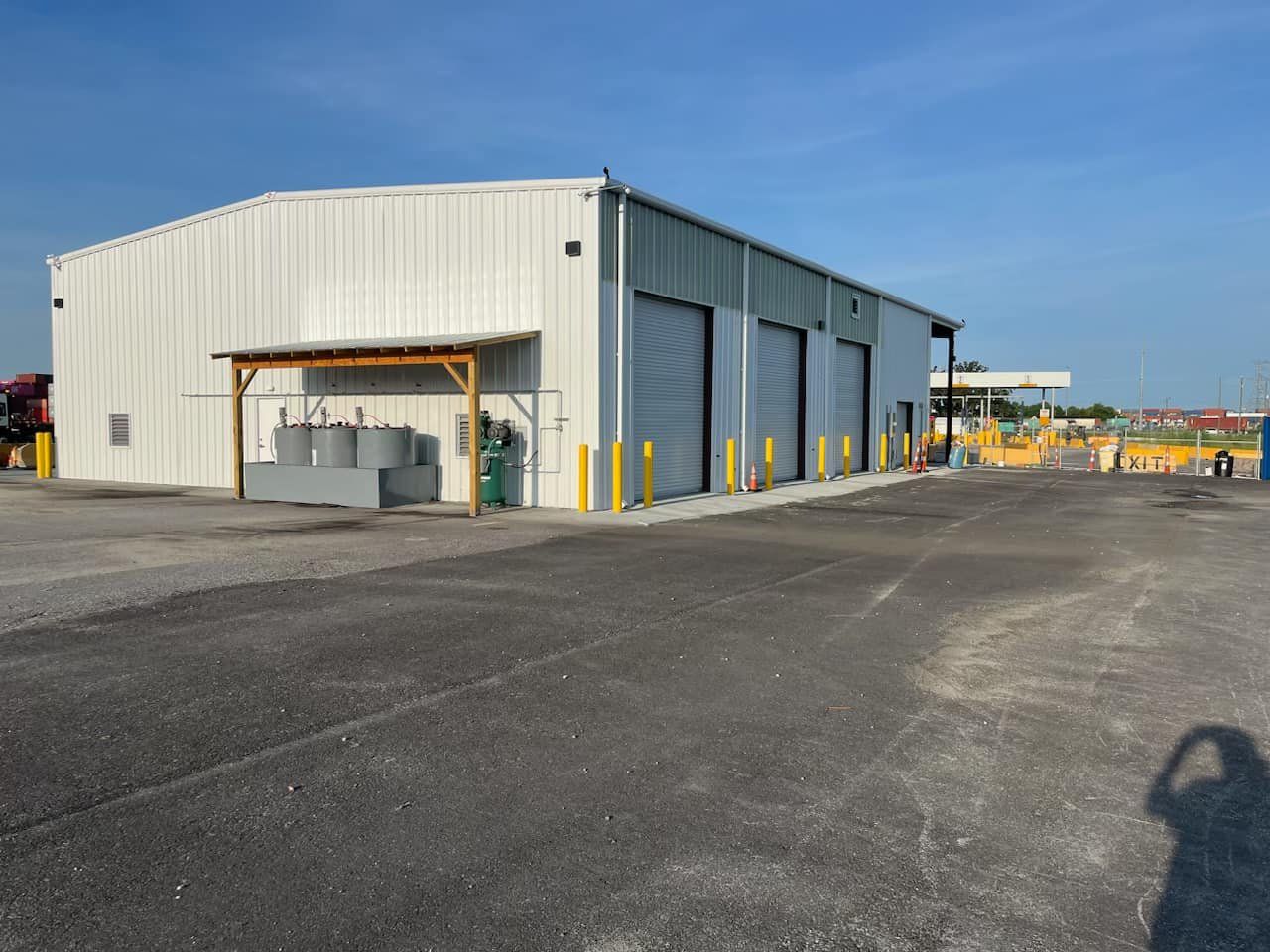 A large white building with a lot of garage doors