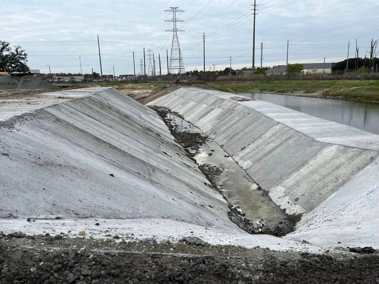 A large body of water with a lot of power lines in the background.